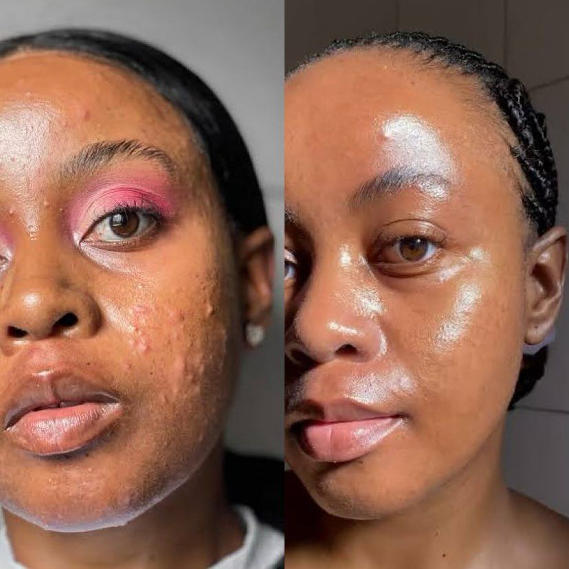 A person with curly hair smiles with a pink face mask applied, against a pink background.